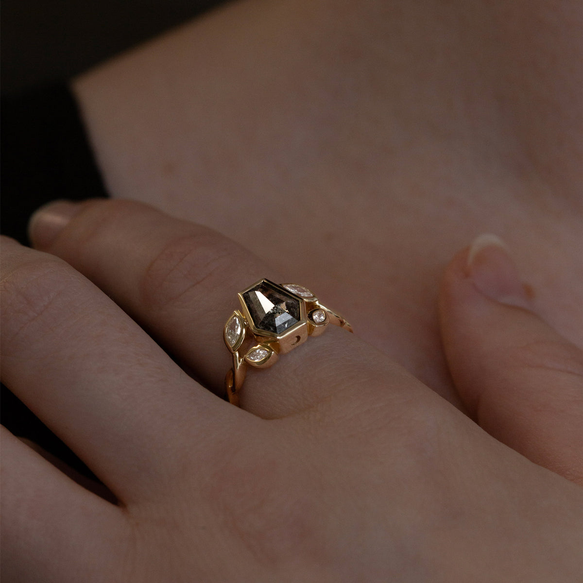 Nick Von K 9 Karat Yellow Gold Ring with Coffin Shaped Salt and Pepper Diamond bezel set with moon cut out and accented by Marquise shaped lab diamonds and twisted vines model shot