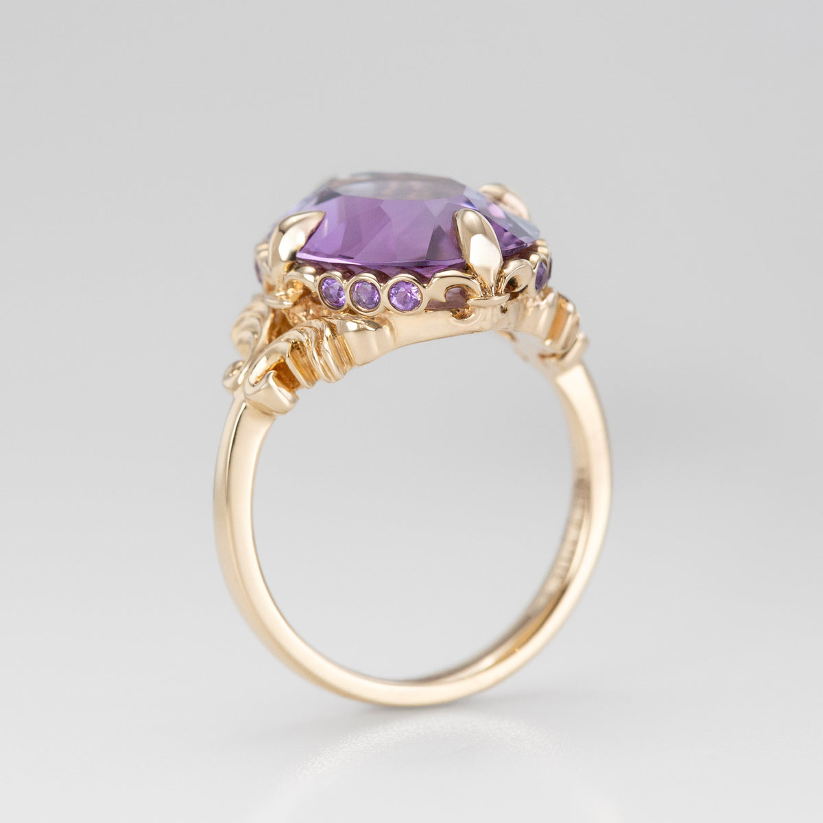 Nick Von K 9k Yellow Gold Royal Unicorn Ring with Amethyst side view of fleur-de-lis claw setting and small gypsy set round cut Amethysts