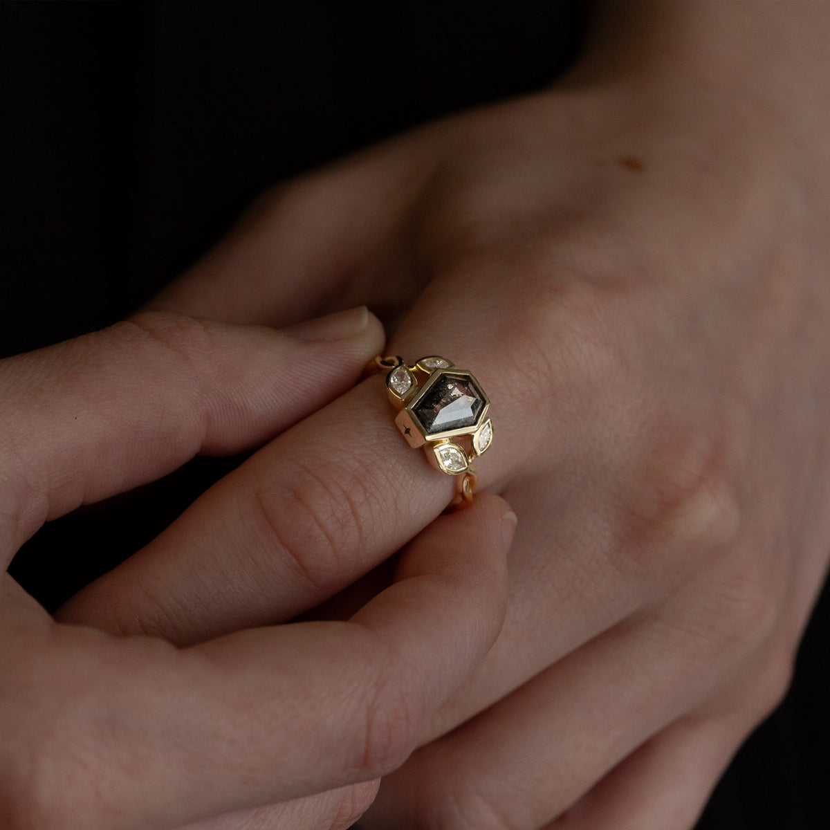 Nick Von K 9 Karat Yellow Gold Ring with Coffin Shaped Salt and Pepper Diamond bezel set with star cut out and accented by Marquise shaped lab diamonds and twisted vines model shot bottom angle 