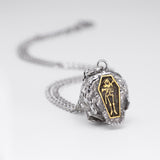 Rear view of the Nick Von K Rebirth charm necklace with the coffin and skeletal reaper detail centred on the skull pendant.