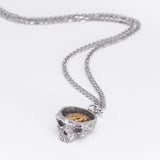 Angled front view of the Nick Von K Rebirth charm necklace with a sculpted skull pendant on a silver chain.