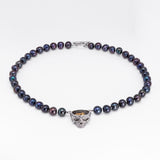 Nick Von K Rebirth necklace with dark iridescent pearls and a skull pendant topped by a gold-toned angel relief.