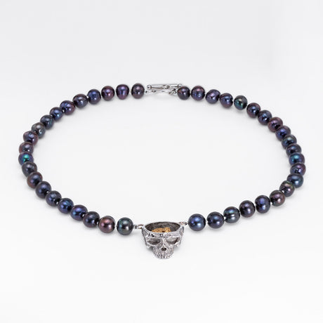 Nick Von K Rebirth necklace with dark iridescent pearls and a skull pendant topped by a gold-toned angel relief.