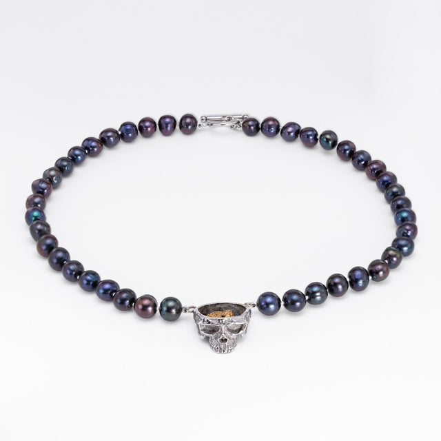 Nick Von K Rebirth necklace with dark iridescent pearls and a skull pendant topped by a gold-toned angel relief.