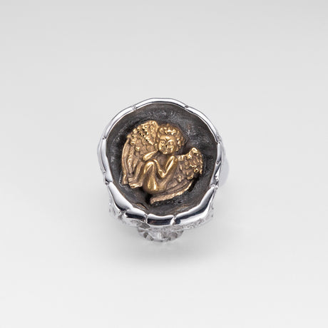 Top view of the Nick Von K Rebirth skull ring showing a gold-toned angel relief in a dark circular setting.