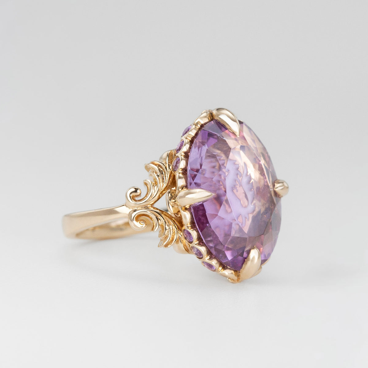 Nick Von K 9k Yellow Gold Royal Unicorn Ring with Amethyst side view of fleur-de-lis claw setting and small gypsy set round cut Amethysts