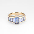 Gold ring with blue sapphires on a white background