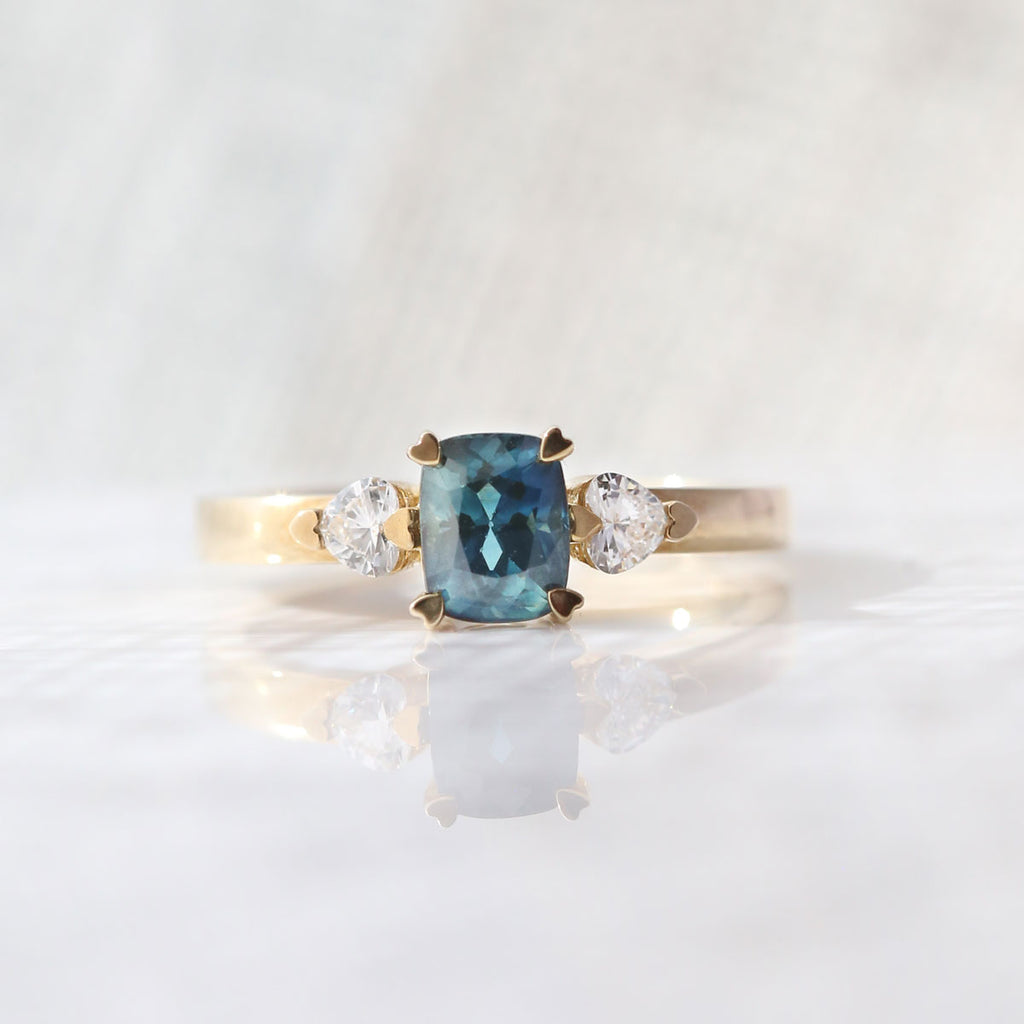 Hidden Hearts Ring with 1.40 carat Teal Parti Sapphire and heart shaped Diamonds in 9 carat Yellow Gold